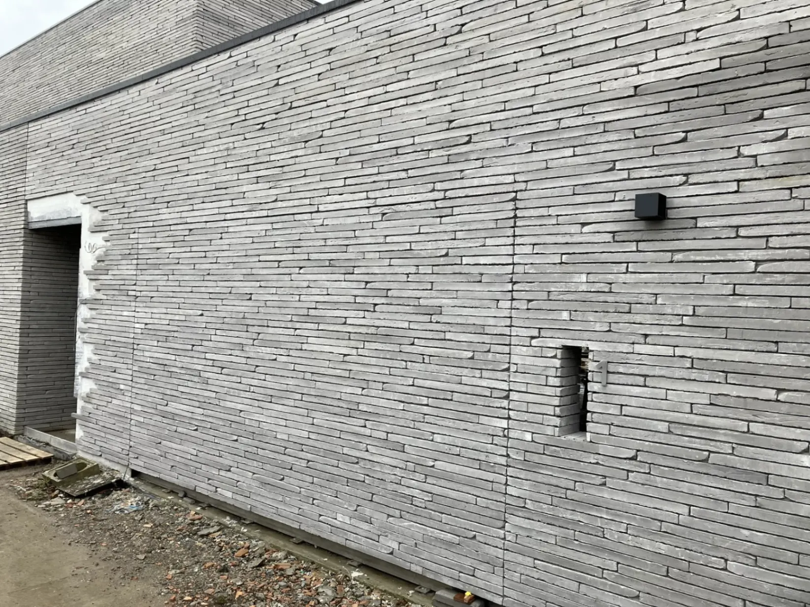 Invisible garage door with natural stone cladding